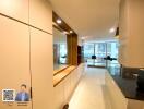 Modern kitchen area with sleek cabinetry and large windows