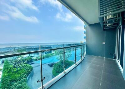 Spacious balcony with ocean view and access to communal pool