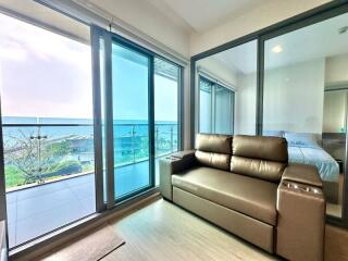 Ocean view modern living room with large windows and comfortable seating