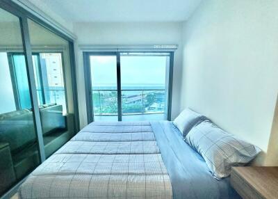 Modern bedroom with ocean view through large glass windows