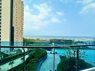 Spacious balcony overlooking a pool and the ocean