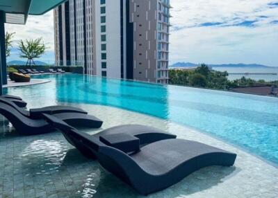 Luxurious infinity pool overlooking the sea with comfortable loungers