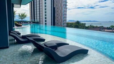 Luxurious infinity pool overlooking the sea with comfortable loungers