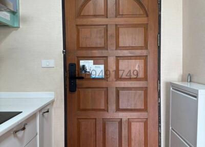 Wooden front door with digital lock in a modern entryway