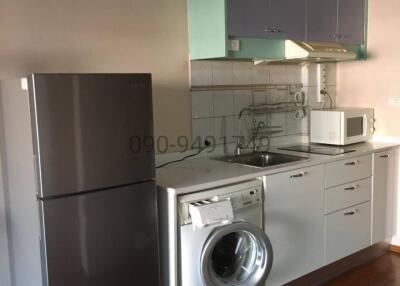 Modern kitchen with stainless steel appliances and white cabinets