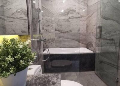 Modern bathroom with marble walls and elegant fixtures