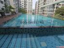 Attractive apartment complex swimming pool surrounded by residential buildings