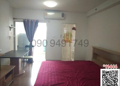 Spacious and well-lit bedroom with air conditioning unit and large window