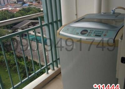 Balcony view with washing machine overlooking urban landscape