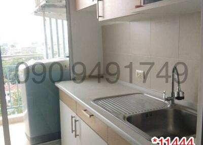 Compact modern kitchen with window view and built-in appliances