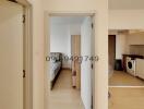 View of a modern apartment hallway leading to bedroom and kitchen