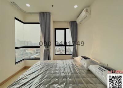 Bright and modern bedroom with large windows and city view