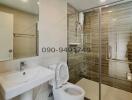 Modern Bathroom with Glass Shower Enclosure and White Fixtures