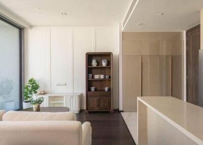 Modern open plan living room with adjoining kitchen and natural light