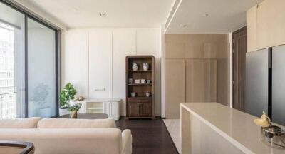 Modern open plan living room with adjoining kitchen and natural light