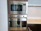 Modern stainless steel kitchen appliances including microwave and oven