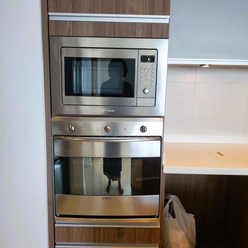 Modern stainless steel kitchen appliances including microwave and oven