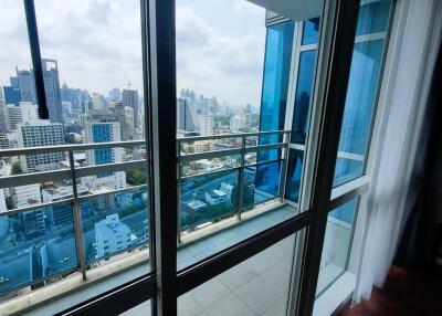 Spacious living room with large windows and city view