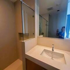 Modern bathroom interior with large mirror and undermount sink