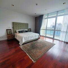 Spacious bedroom with large windows and city view