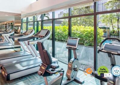 Modern gym facility with pool view in a residential building