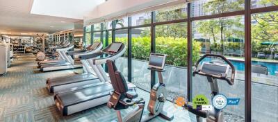 Modern gym facility with pool view in a residential building