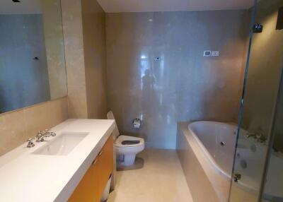 Spacious modern bathroom with bathtub and glass shower