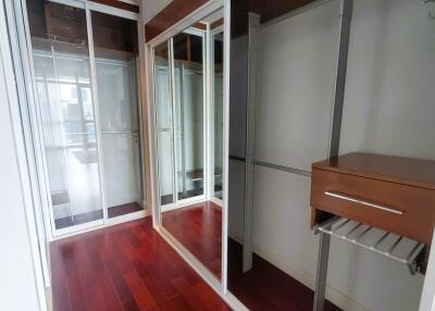 Spacious bedroom with built-in wardrobes and wooden flooring