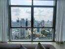 City view from the living room with large windows and comfortable seating