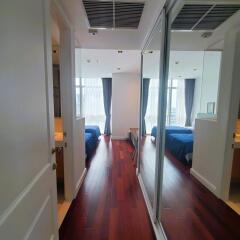 Spacious bedroom interior with mirror wardrobe doors and hardwood flooring