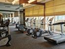 Modern gym in residential building with extensive workout equipment