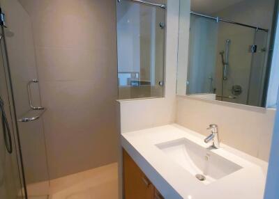 Modern bathroom with spacious vanity and glass-enclosed shower