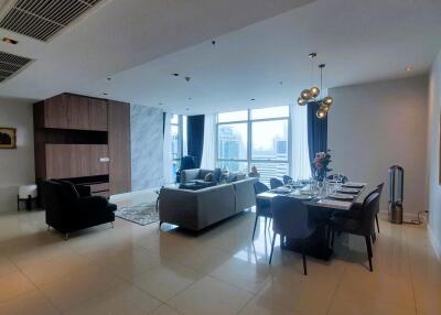Spacious modern living room with dining area and city views