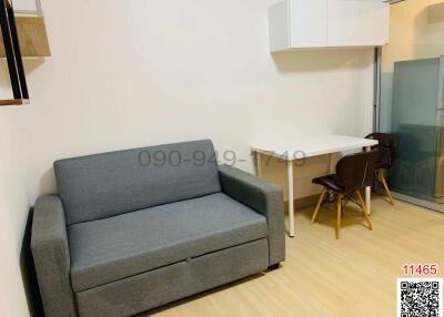Compact living room with modern sofa and dining area
