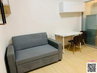 Compact living room with modern sofa and dining area