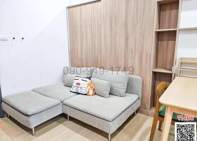 Spacious and modern living room with a large sofa and wooden storage units