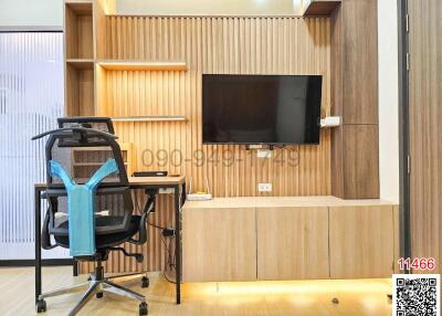 Modern home office with wooden shelving, desk, and ergonomic chair