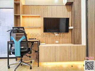 Modern home office with wooden shelving, desk, and ergonomic chair