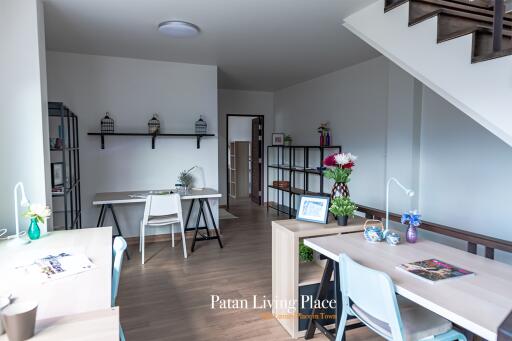 Spacious modern living room with staircase and dining area