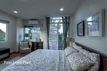 Elegant modern bedroom with natural lighting through a large window