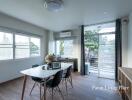 Spacious and well-lit living room with modern furniture and large windows