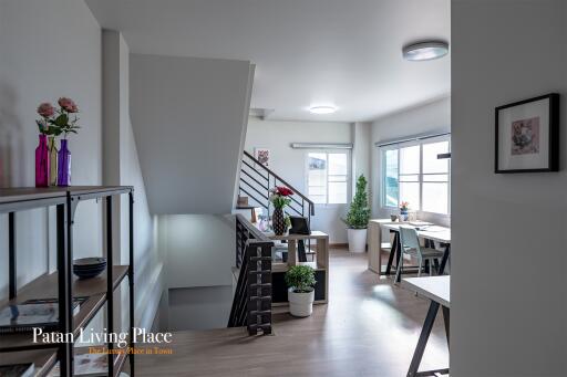 Spacious modern living room with dining area and staircase