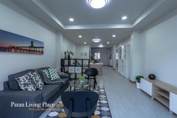 Spacious and modern living room with stylish decor and ample lighting