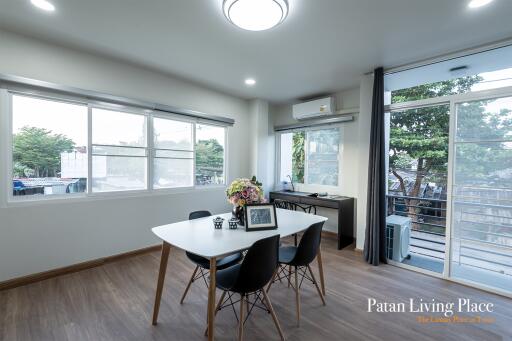 Spacious modern living room with dining area and balcony access