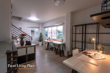 Modern spacious living room with dining area and staircase