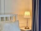 Cozy and well-lit bedroom corner with elegant furnishings