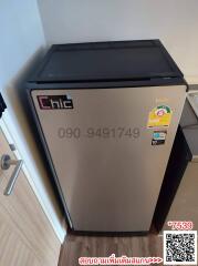 Compact stainless steel refrigerator in a modern kitchen