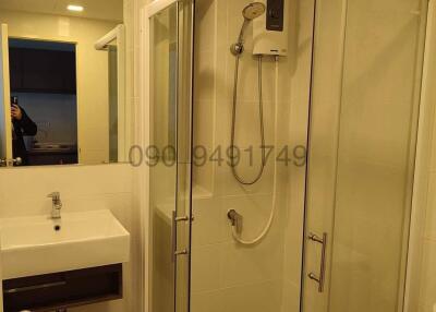 Modern bathroom with glass shower and white sink