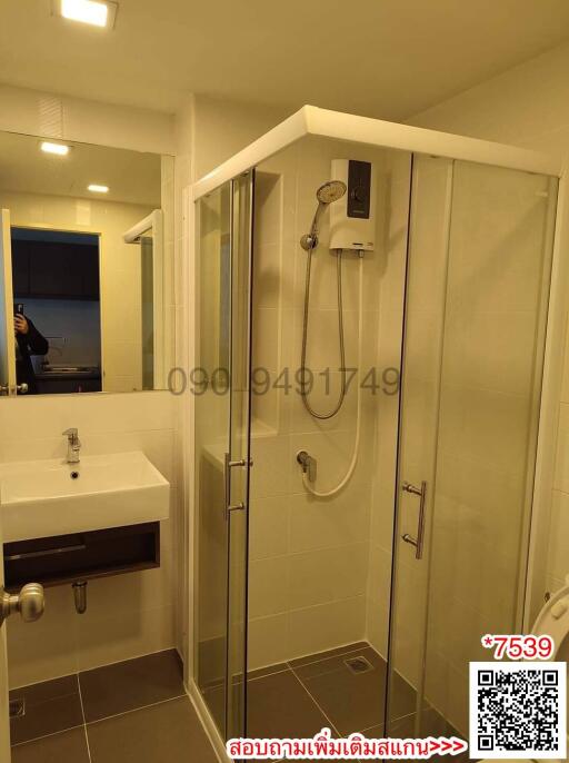 Modern bathroom with glass shower and white sink