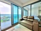 Spacious ocean view living room with large windows and comfortable seating